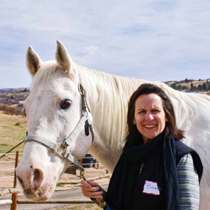 Woman smiling with horse