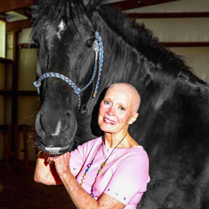 Woman smiling with horse